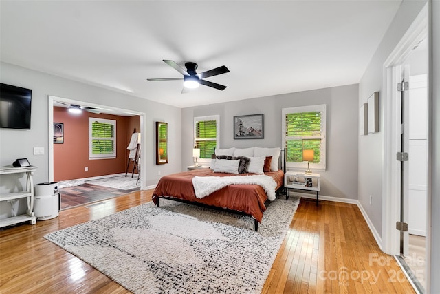 3407 Patton Rd, Franklin, NC 28734 - bedroom with multiple windows, light wood finished floors, and baseboards