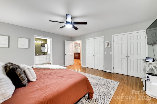 3407 Patton Rd, Franklin, NC 28734 - bedroom with two closets, light wood-style flooring, ensuite bath, and ceiling fan