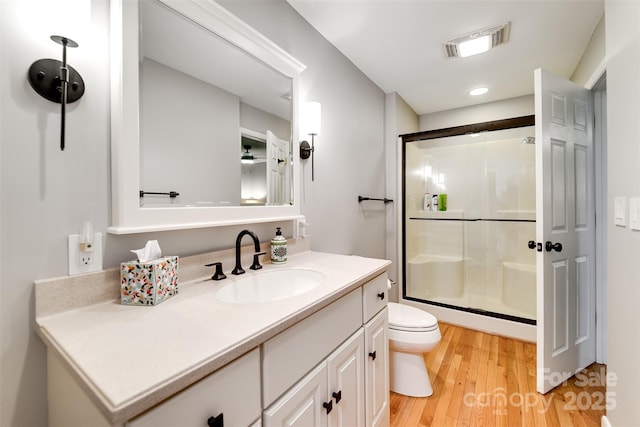 3407 Patton Rd, Franklin, NC 28734 - full bathroom featuring a shower stall, vanity, wood finished floors, and toilet