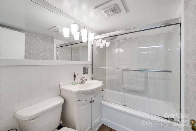 3407 Patton Rd, Franklin, NC 28734 - bathroom featuring vanity, toilet, combined bath / shower with glass door, and tile walls