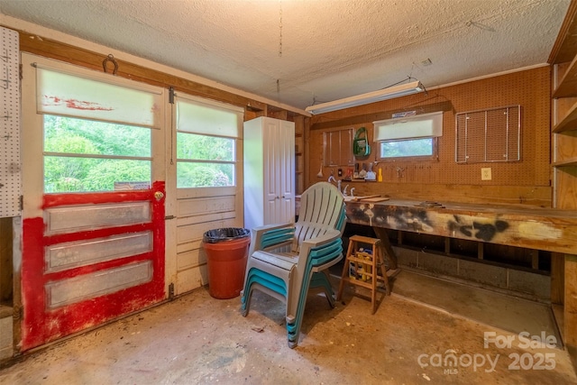 3407 Patton Rd, Franklin, NC 28734 - dining room with a workshop area, a textured ceiling, and unfinished concrete floors