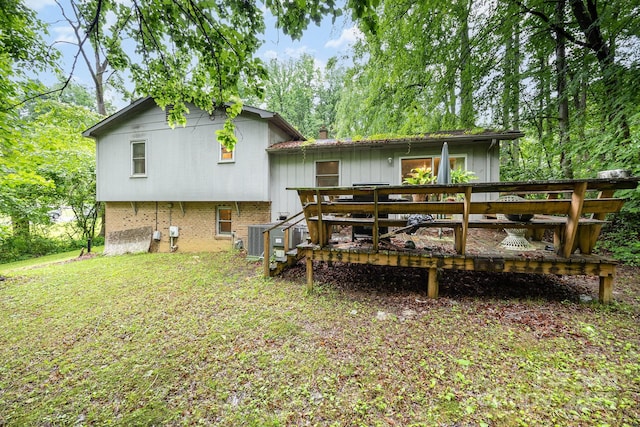 back of house featuring a wooden deck, central AC, and a chimney