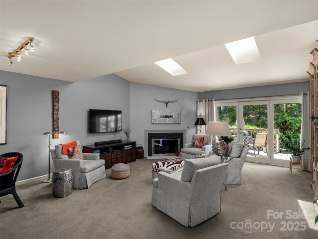 118 Cloverleaf Ln, Asheville, NC 28803 - carpeted living area with french doors, a glass covered fireplace, rail lighting, and baseboards