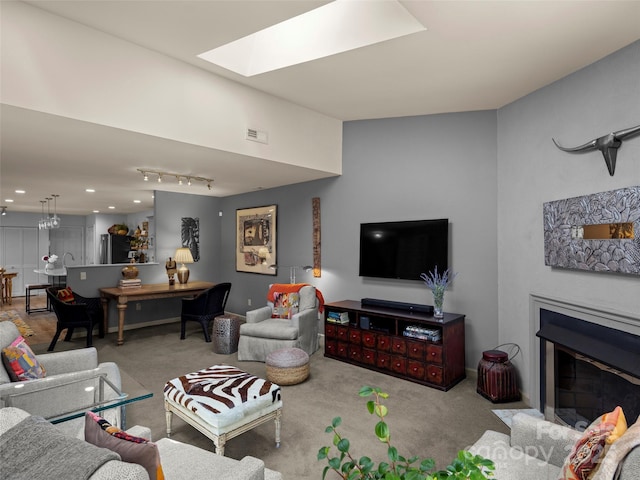 118 Cloverleaf Ln, Asheville, NC 28803 - living room featuring carpet, a glass covered fireplace, and a skylight