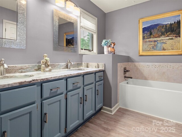 118 Cloverleaf Ln, Asheville, NC 28803 - bathroom with wood finished floors, double vanity, and a bath