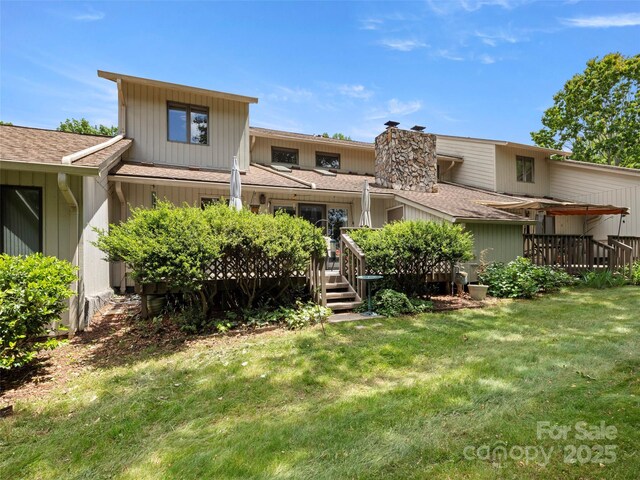 118 Cloverleaf Ln, Asheville, NC 28803 - back of property with a deck, a lawn, roof with shingles, and a chimney