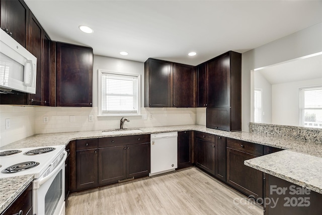 752 Chipmeadow Ln, York, SC 29745 - kitchen with white appliances, a sink, tasteful backsplash, light wood-style floors, and light stone countertops