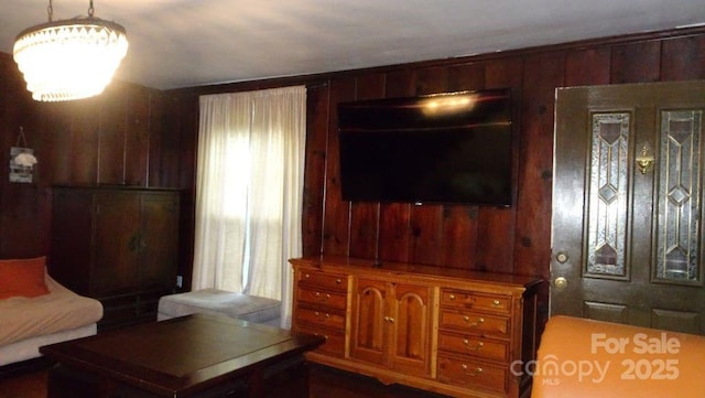 living area featuring wood walls