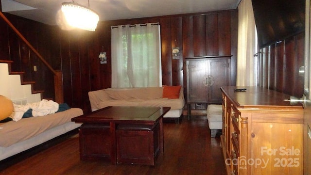 living area with dark wood-style flooring and stairway