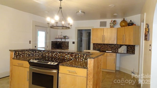 kitchen featuring stainless steel electric range oven, tasteful backsplash, light tile patterned floors, and a chandelier