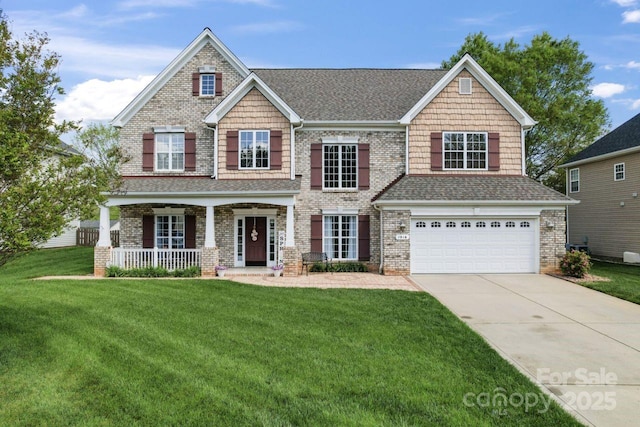 1016 Spanish Moss Rd, Indian Trail, NC 28079 - craftsman-style house featuring covered porch, an attached garage, concrete driveway, a front lawn, and roof with shingles