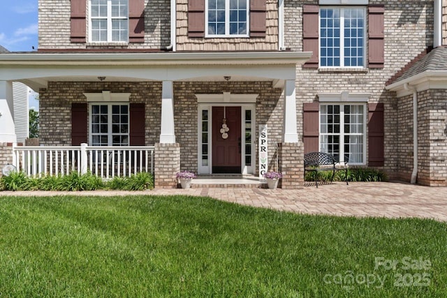 1016 Spanish Moss Rd, Indian Trail, NC 28079 - property entrance featuring brick siding, a porch, and a lawn