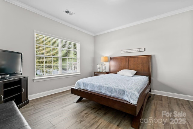 1016 Spanish Moss Rd, Indian Trail, NC 28079 - bedroom with ornamental molding, wood finished floors, and baseboards
