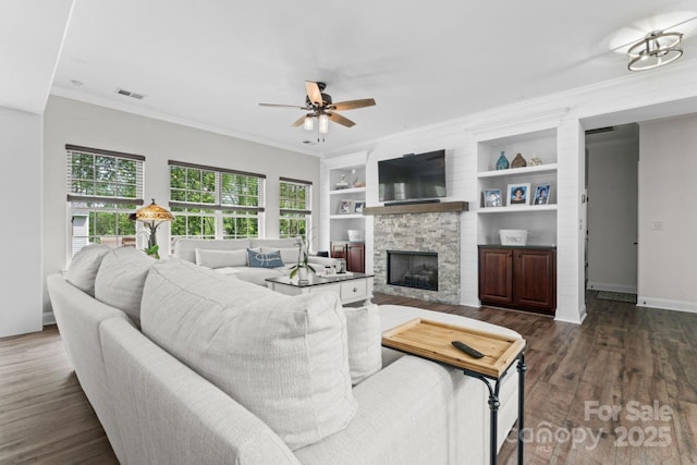 1016 Spanish Moss Rd, Indian Trail, NC 28079 - living area featuring ceiling fan, dark wood-type flooring, a fireplace, crown molding, and baseboards