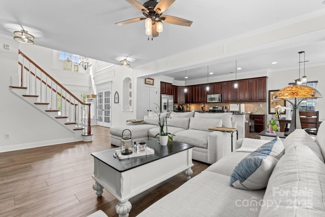 1016 Spanish Moss Rd, Indian Trail, NC 28079 - living area with a ceiling fan, dark wood-style floors, stairs, arched walkways, and baseboards