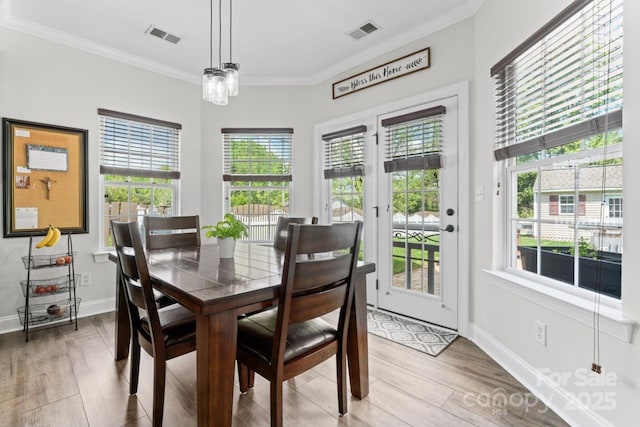 1016 Spanish Moss Rd, Indian Trail, NC 28079 - dining area with healthy amount of natural light, wood finished floors, crown molding, and baseboards