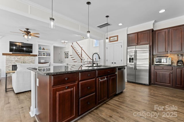 1016 Spanish Moss Rd, Indian Trail, NC 28079 - kitchen with appliances with stainless steel finishes, a sink, wood finished floors, ceiling fan, and ornamental molding