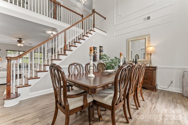 1016 Spanish Moss Rd, Indian Trail, NC 28079 - dining area with wood finished floors, ceiling fan, stairway, baseboards, and a towering ceiling