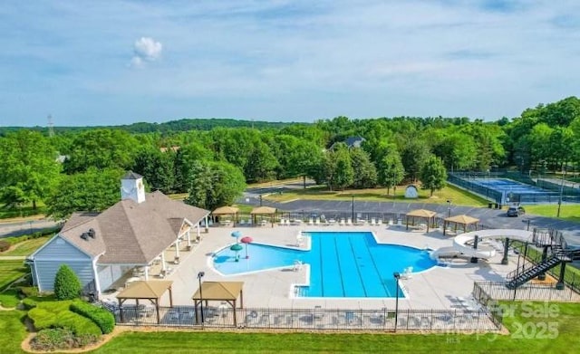 1016 Spanish Moss Rd, Indian Trail, NC 28079 - community pool with fence, a forest view, and a patio area
