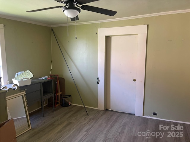 office area featuring wood finished floors, a ceiling fan, and crown molding