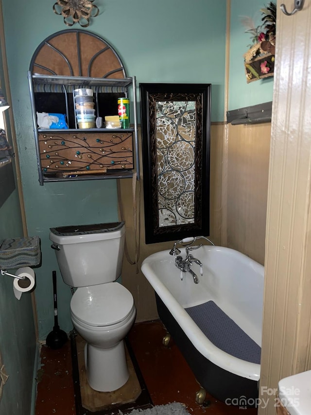 full bathroom featuring toilet and a soaking tub
