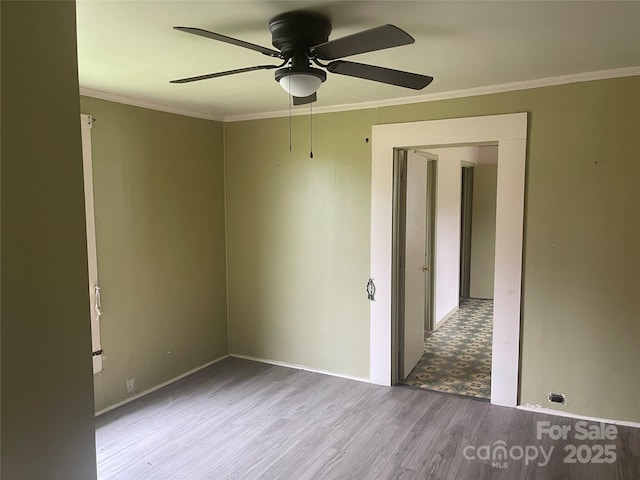 1418 Old Wilkesboro Rd, Salisbury, NC 28144 - empty room with wood finished floors, a ceiling fan, ornamental molding, and baseboards