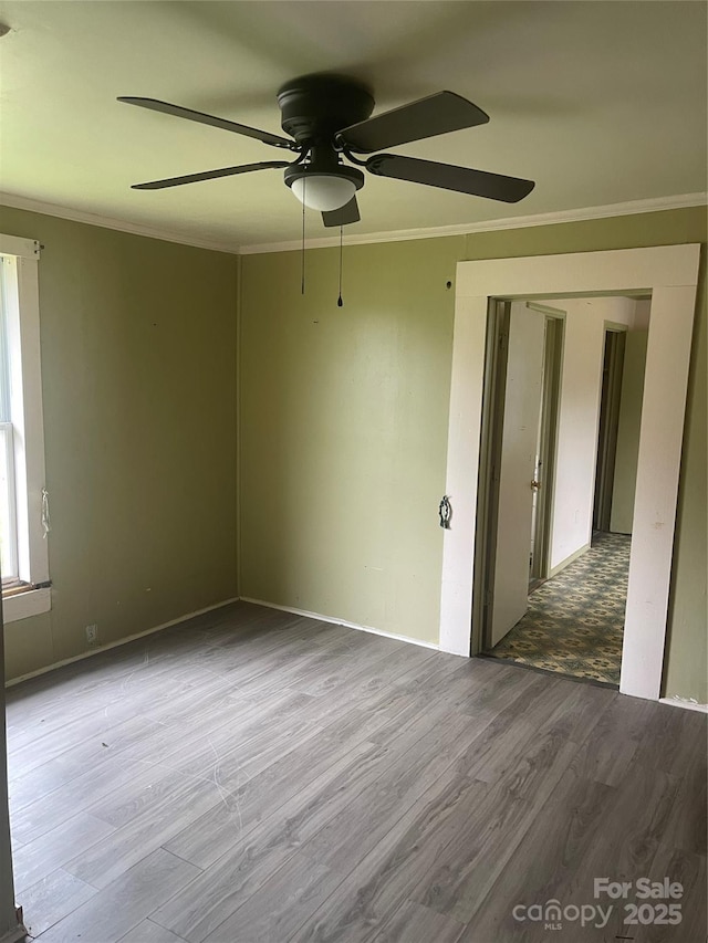 1418 Old Wilkesboro Rd, Salisbury, NC 28144 - unfurnished room with wood finished floors, crown molding, ceiling fan, and baseboards