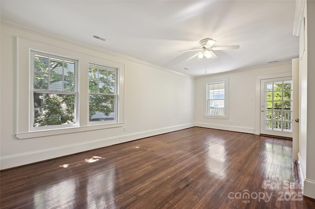 unfurnished room with wood finished floors, ceiling fan, baseboards, and ornamental molding