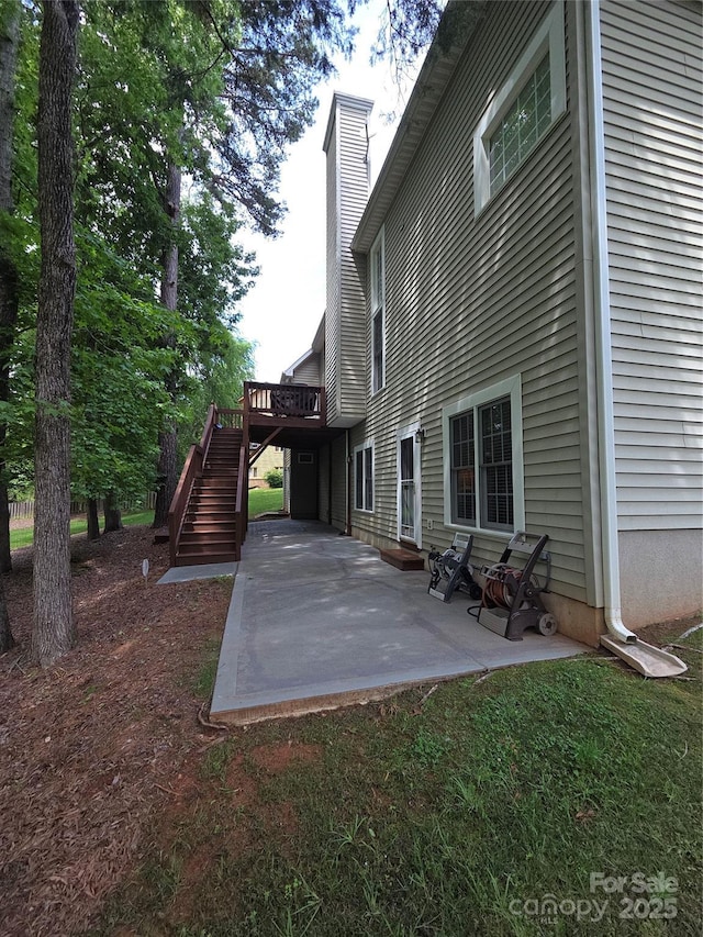 1253 Iverleigh Trl, Charlotte, NC 28270 - back of property with a chimney, a patio, stairway, and a deck