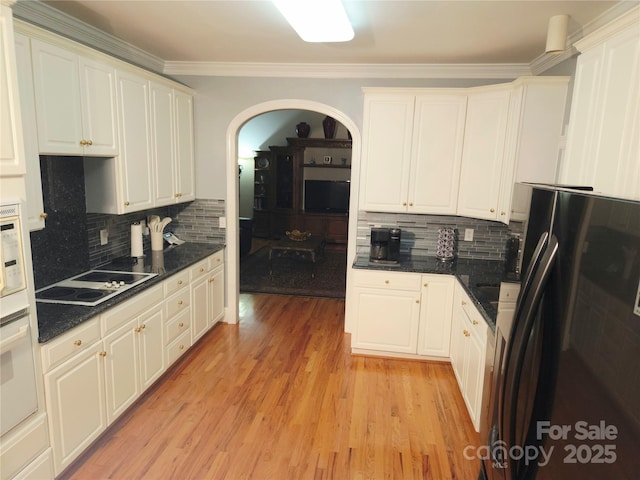 1253 Iverleigh Trl, Charlotte, NC 28270 - kitchen featuring freestanding refrigerator, electric cooktop, arched walkways, decorative backsplash, and ornamental molding