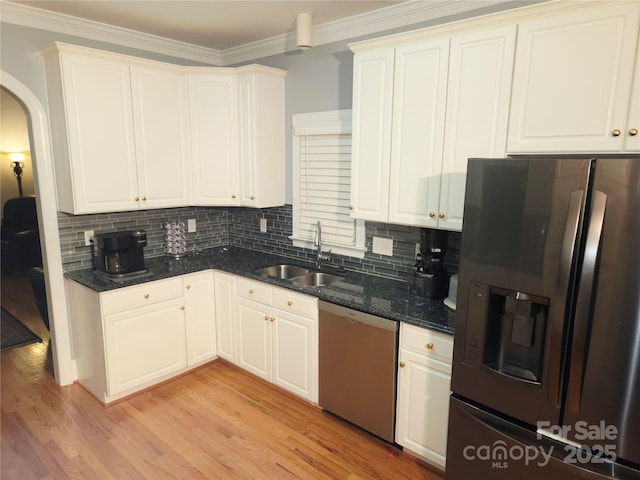 1253 Iverleigh Trl, Charlotte, NC 28270 - kitchen with appliances with stainless steel finishes, a sink, decorative backsplash, crown molding, and light wood finished floors