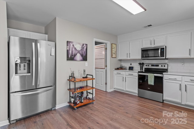 176 Pleasant Grove Ln, Mooresville, NC 28115 - kitchen featuring stainless steel appliances, white cabinetry, and tasteful backsplash