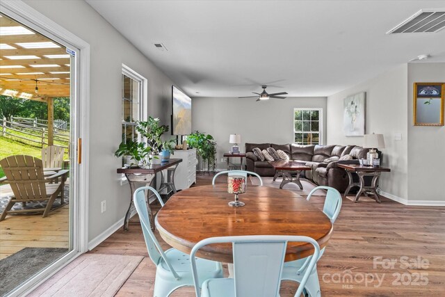 176 Pleasant Grove Ln, Mooresville, NC 28115 - dining area featuring light wood-type flooring, a ceiling fan, and baseboards