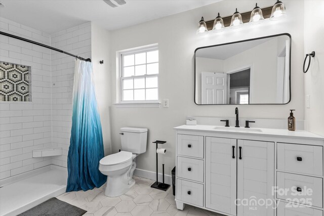176 Pleasant Grove Ln, Mooresville, NC 28115 - bathroom featuring toilet, tiled shower, tile patterned floors, vanity, and baseboards