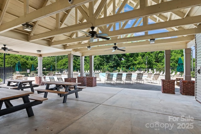 176 Pleasant Grove Ln, Mooresville, NC 28115 - view of patio / terrace with ceiling fan, fence, view of wooded area, and a pool
