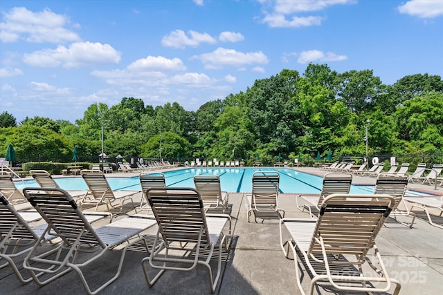 176 Pleasant Grove Ln, Mooresville, NC 28115 - community pool featuring a patio, fence, and view of wooded area