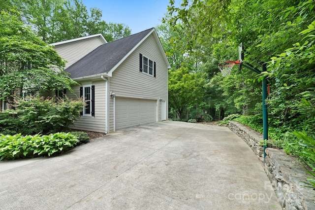 226 Duncan Estate Dr, Fletcher, NC 28732 - view of property exterior featuring an attached garage, roof with shingles, and concrete driveway