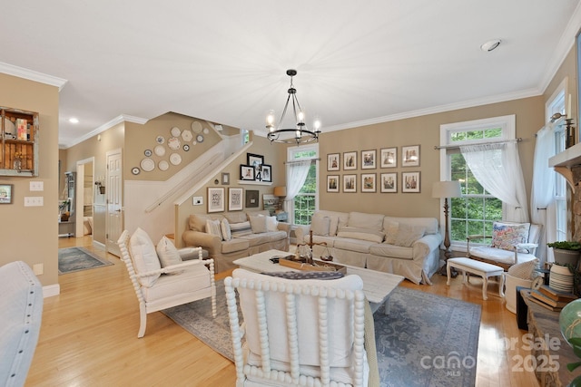 226 Duncan Estate Dr, Fletcher, NC 28732 - living room with light wood-type flooring, a chandelier, stairway, and crown molding