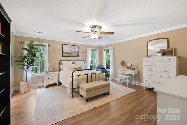 226 Duncan Estate Dr, Fletcher, NC 28732 - bedroom featuring wood finished floors, crown molding, baseboards, and a ceiling fan