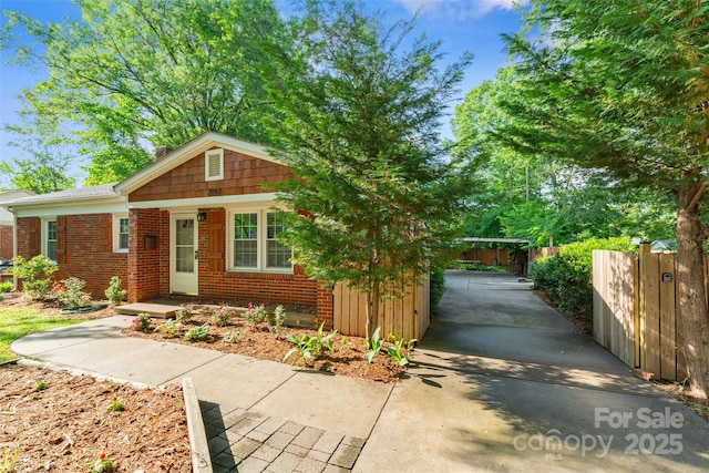 2953 Enfield Rd, Charlotte, NC 28205 - view of front of house with brick siding, fence, and concrete driveway