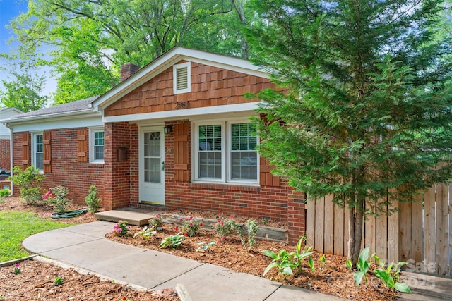 2953 Enfield Rd, Charlotte, NC 28205 - view of front of home featuring a chimney, fence, and brick siding