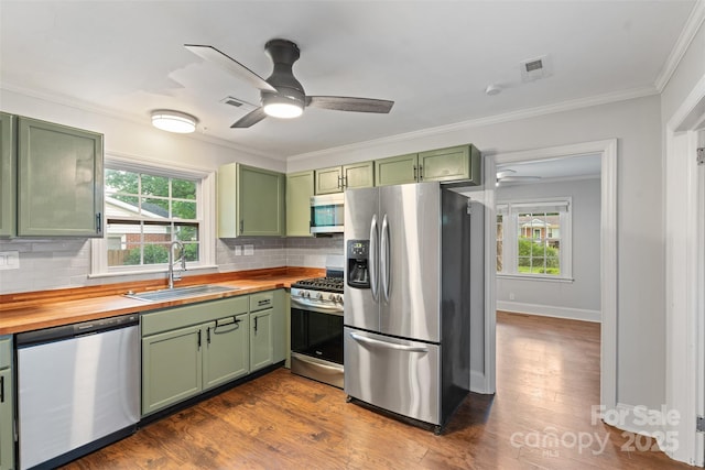 2953 Enfield Rd, Charlotte, NC 28205 - kitchen featuring green cabinets, appliances with stainless steel finishes, wood counters, a sink, and ceiling fan