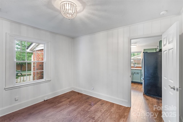 2953 Enfield Rd, Charlotte, NC 28205 - unfurnished room featuring dark wood-type flooring, plenty of natural light, baseboards, and a chandelier