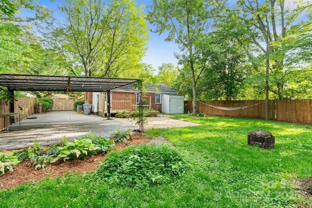 2953 Enfield Rd, Charlotte, NC 28205 - view of yard with a fire pit, a storage unit, and an outbuilding