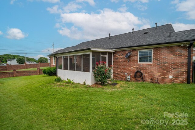 1909 Wexford Ct, Gastonia, NC 28054 - rear view of property featuring a sunroom, a yard, brick siding, and a shingled roof