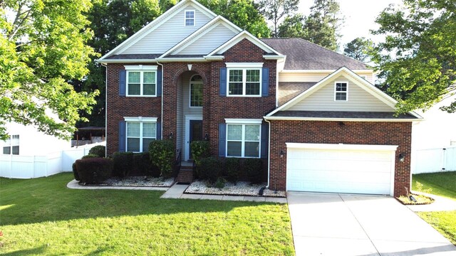 14615 Bridle Trace Ln, Pineville, NC 28134 - traditional home featuring concrete driveway, brick siding, and a garage