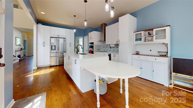 14615 Bridle Trace Ln, Pineville, NC 28134 - kitchen with stainless steel appliances, a sink, wall chimney exhaust hood, wood finished floors, and an island with sink