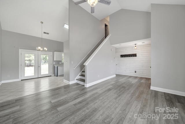 2706 Stagbuck Dr, Gastonia, NC 28052 - unfurnished living room featuring high vaulted ceiling, stairs, a ceiling fan, a chandelier, and baseboards