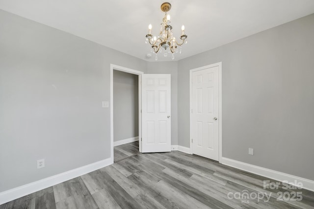 2706 Stagbuck Dr, Gastonia, NC 28052 - unfurnished room with a chandelier, baseboards, and wood finished floors