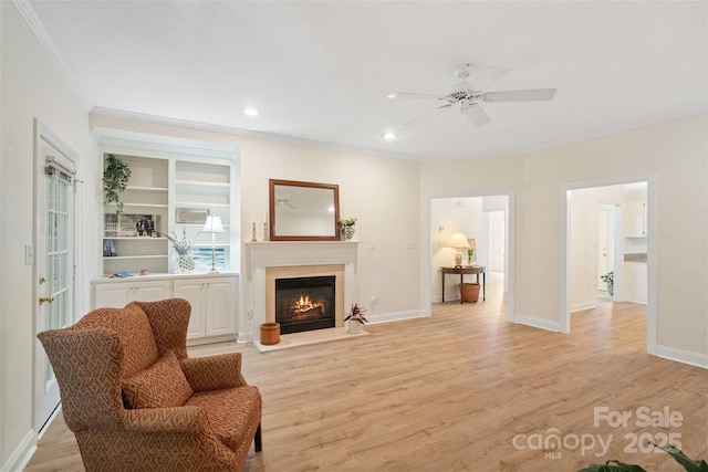 608 Camrose Cir NE, Concord, NC 28025 - living room featuring ornamental molding, ceiling fan, light wood-type flooring, a warm lit fireplace, and recessed lighting